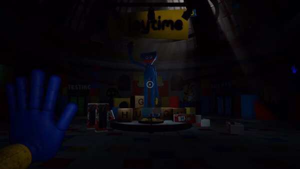 Screenshot from Poppy Playtime showing Huggy Wuggy standing in a dimly lit playroom with a blue toy hand in the foreground.