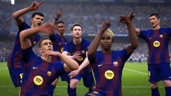 A team of players celebrates a goal in a stadium in an eFootball™ game screenshot, wearing blue and red jerseys.