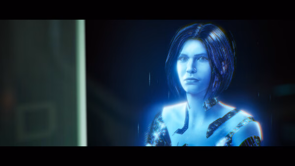 A holographic character appears in this Halo: Campaign Evolved screenshot, glowing with blue light and digital effects.