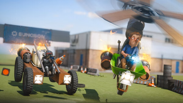 s&box screenshot: A player rides a green helicopter, while another drives a flaming vehicle in a grassy area with buildings nearby.