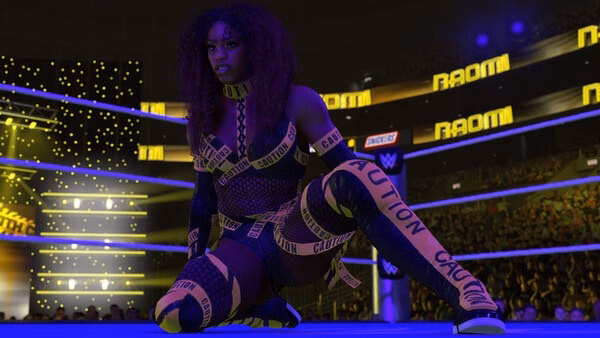 A WWE 2K26 screenshot showing a wrestler kneeling in the ring, wearing a caution-tape-themed outfit under bright arena lights.