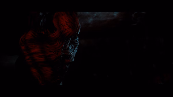 A screenshot from SILENT HILL: Townfall showing a dark, eerie figure with glowing red and black textures in a shadowy environment.